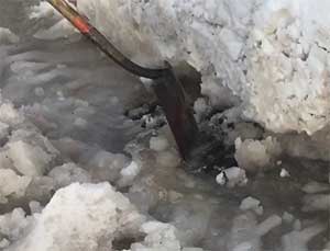 Photograph of snow on storm drain